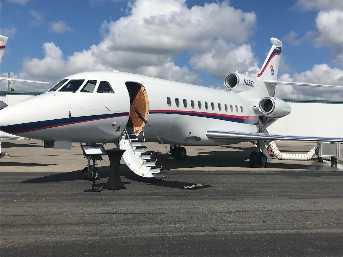 Dassault Falcon private jet with airstairs extended at a private FBO terminal