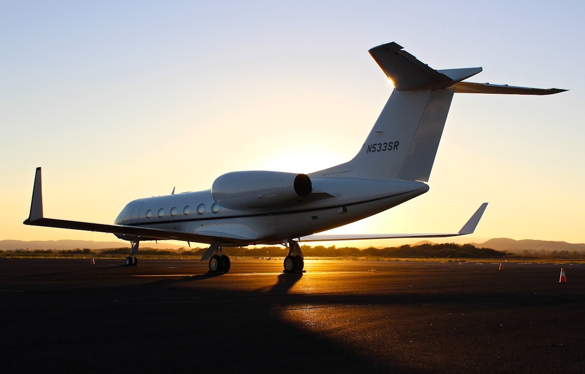 Private Gulfstream jet on tarmac at sunset